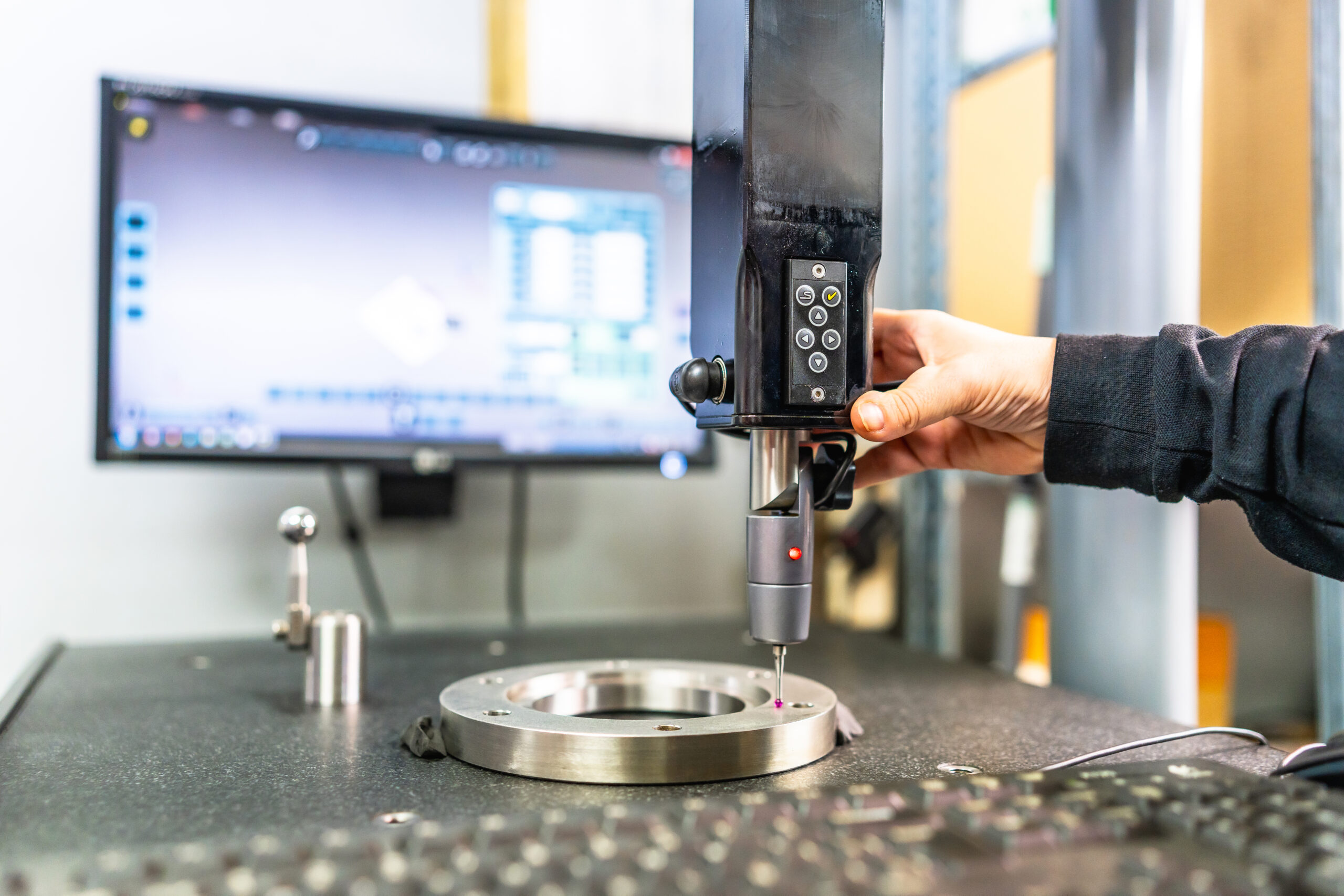Technician working with three-dimensional verification and measuring machine Close-up of the hand of a technician working with three-dimensional verification and measuring machine in a cnc innovative metal factory